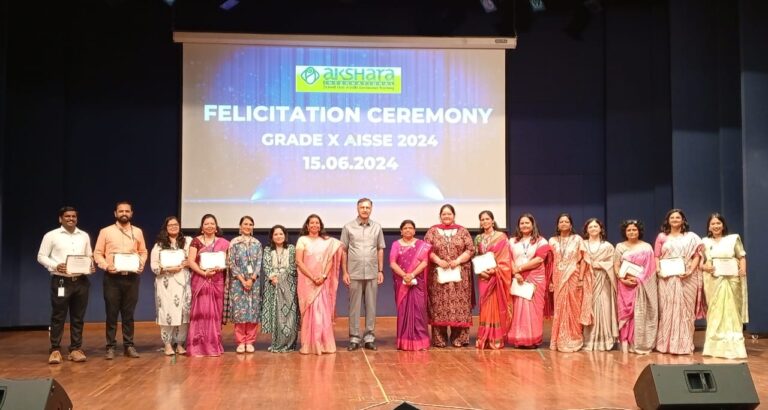 Students and faculties standing on stage with a certificate in hand