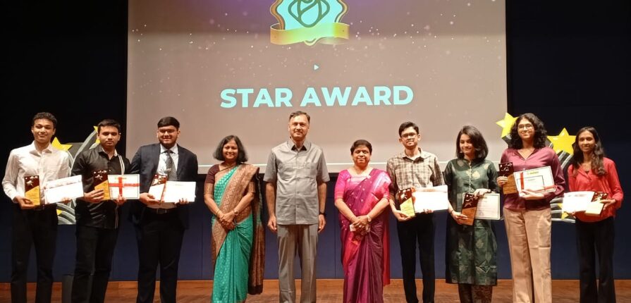 felicitation ceremony, student, student with certificate in hand, students on stage