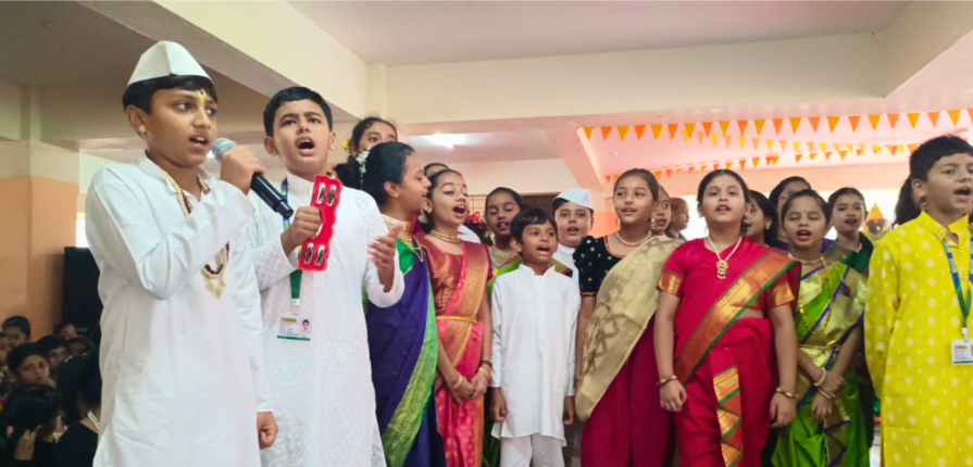 A diverse group of individuals in vibrant saris and kurtas singing joyfully together.